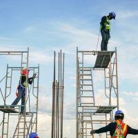 Construction workers climbing on scaffolding